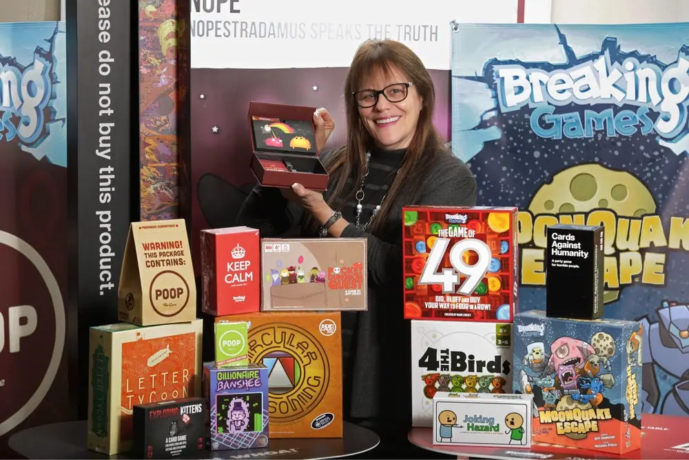 Shari Spiro posing with the games that Admagic has published